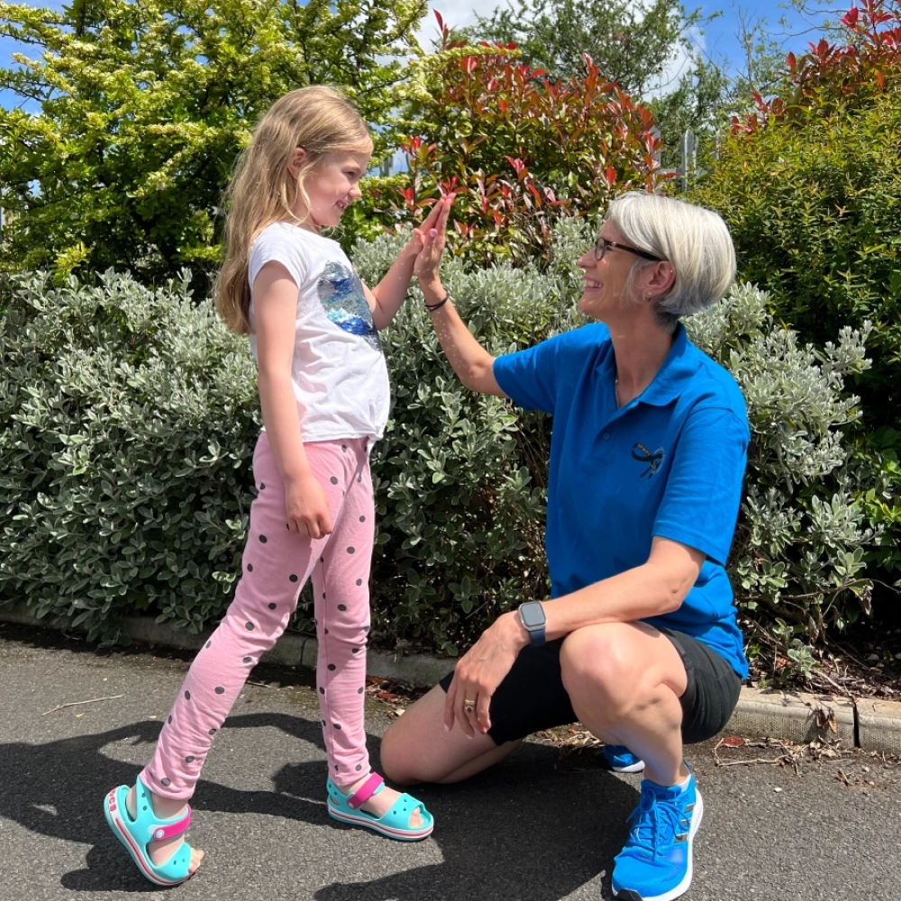 Natalie high-fiving child she has coached